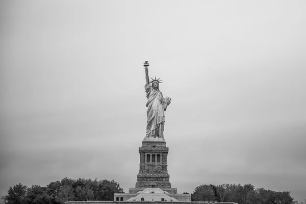 Statue of Liberty in NYC on cloudy sky