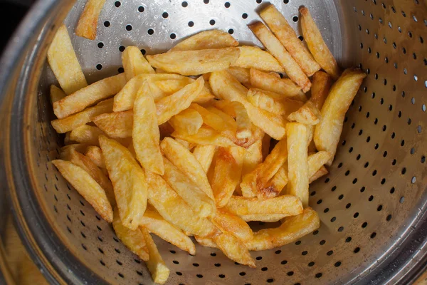 A lot of delicious french fries cooked at home on a white background
