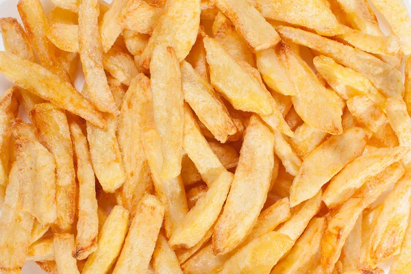 A lot of delicious french fries cooked at home on a white background