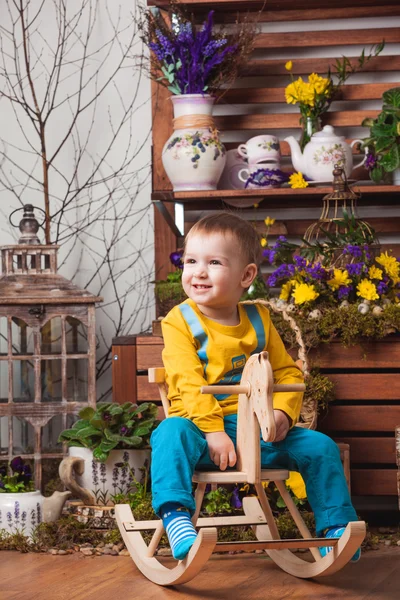 Children on the background of spring decor in yellow T-shirts , flower meadow .