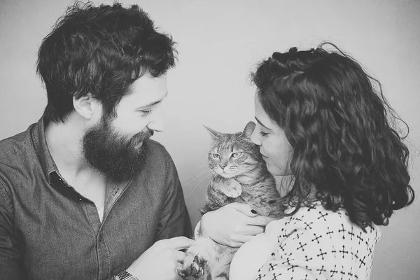 Happy young couple with cat