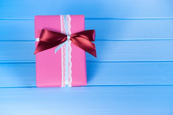 Packed box, gift on a wooden light-blue background. Selective focus, toned image, film effect