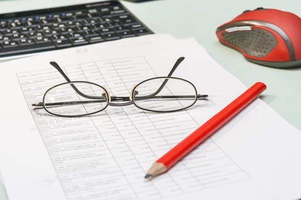 Not staged work with documents at home. Documents, pencil, glasses, keyboard.