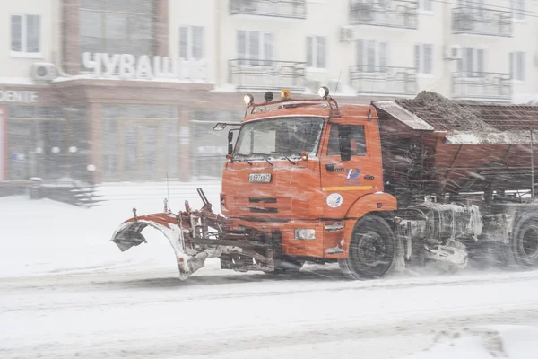 Special technique removes the snow from the street during a snow storm in poor visibility. Snow storm in the city of Cheboksary, Chuvash Republic, Russia. 01/17/2016