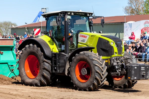 German claas axion tractor drives on track