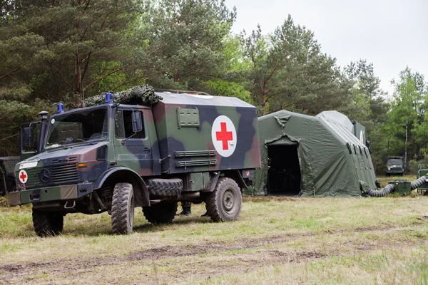 German military ambulance stands on rescue center system in a wood