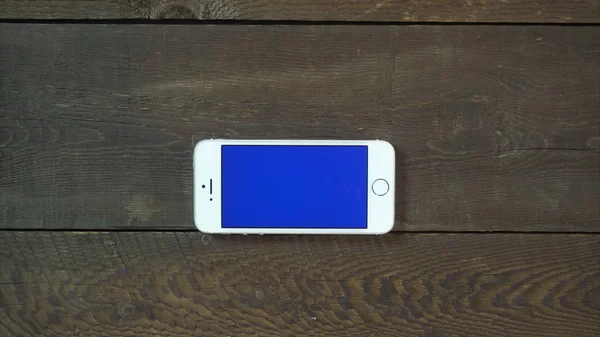 Zoom Out Hand Smartphone with Blue Screen