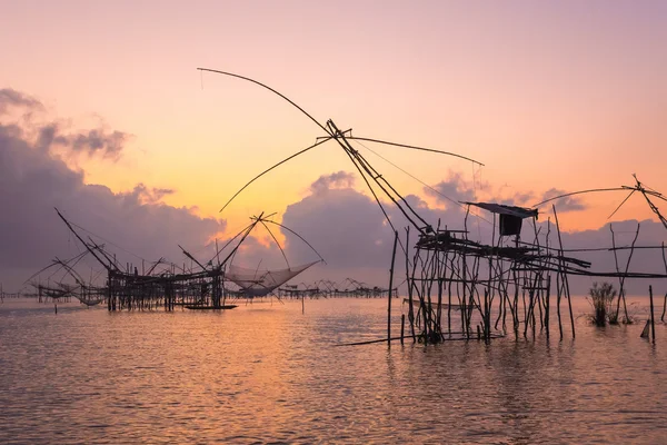 Silhouette big fish net traps in the dawn.