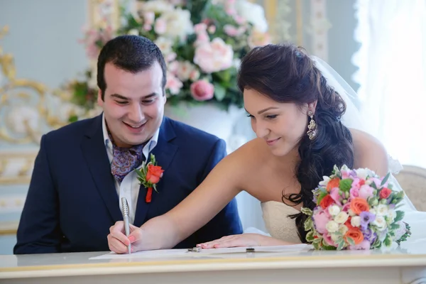 Bride and groom registering marriage