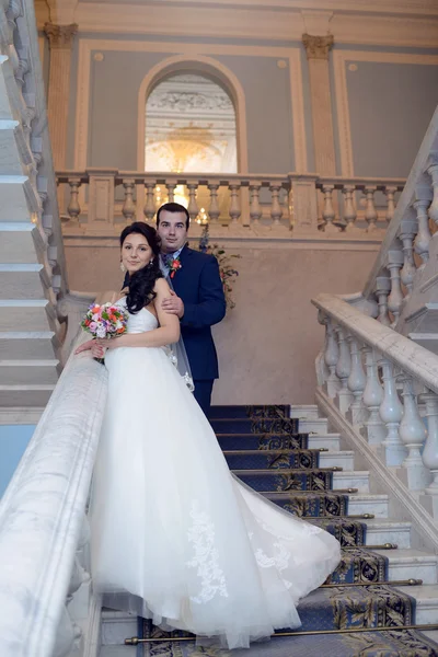 Wedding couple hugging on stairs