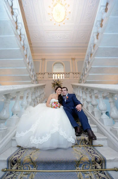 Wedding couple hugging on stairs