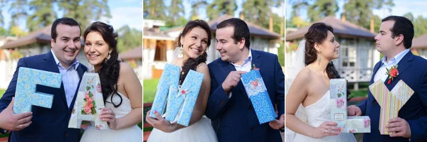 Beautiful wedding couple holding letters