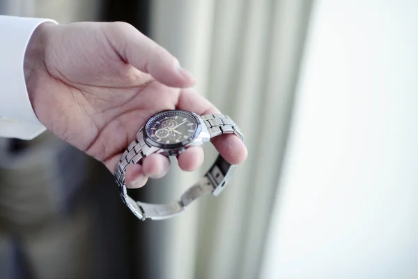 Groom wearing wrist watch