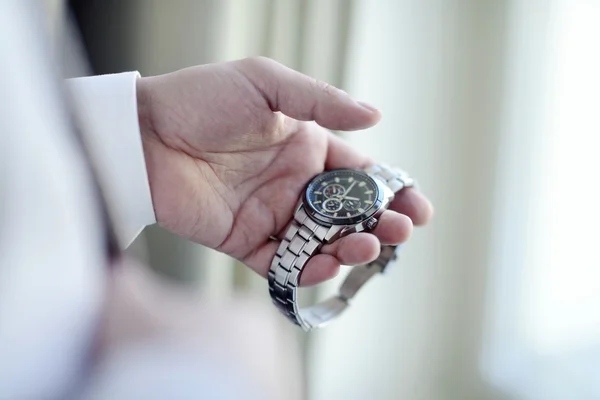 Groom wearing wrist watch