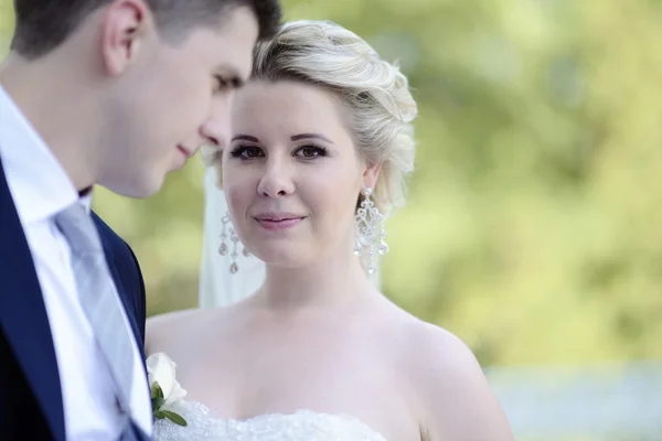 Beautiful bride and groom hugging in park