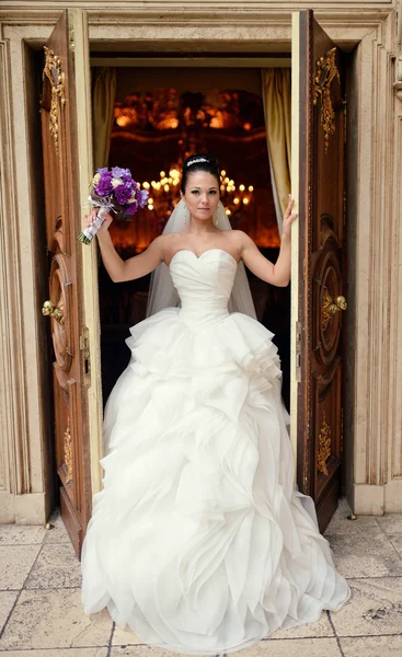 Beautiful brunette bride holding bouquet