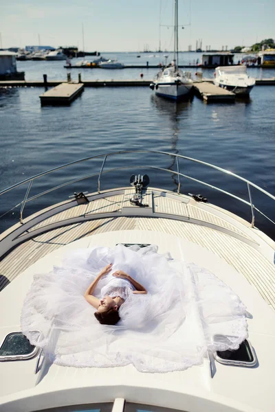 Beautiful bride in wedding dress on yacht