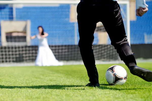 Wedding couple playing football
