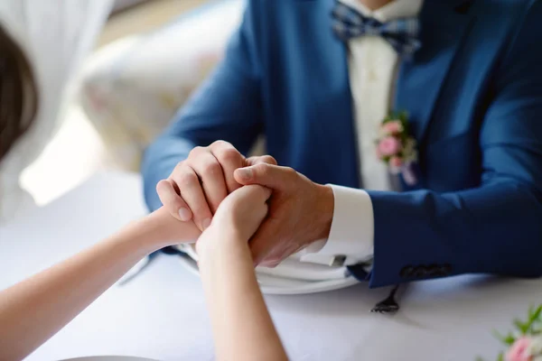 Wedding couple holding hands