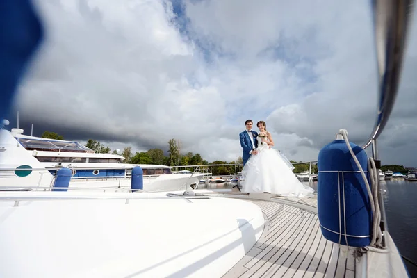 Wedding couple hugging on yacht