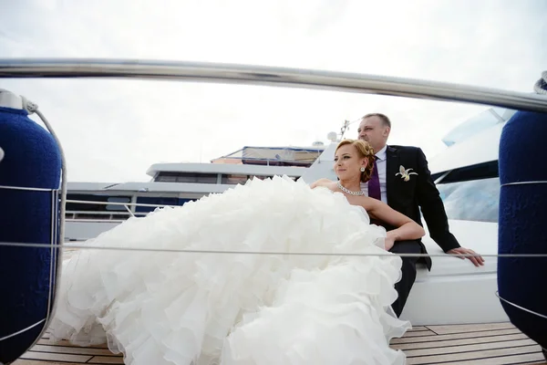 Wedding couple hugging on yacht