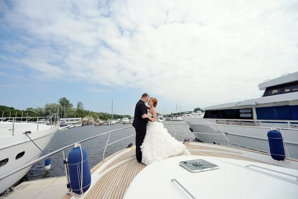 Wedding couple hugging on yacht