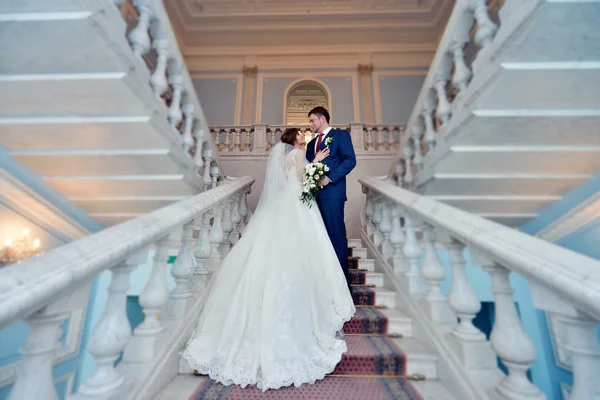 Wedding couple hugging on stairs