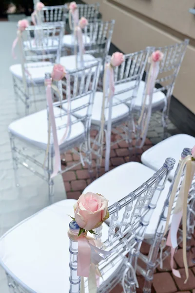Fabric bows with roses on chairs