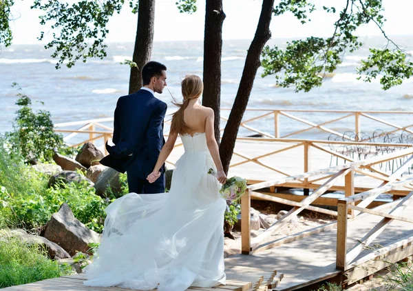 Wedding couple walking near sea