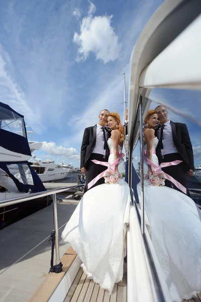 Wedding couple hugging on yacht