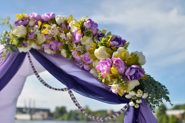 Purple wedding arch with flowers