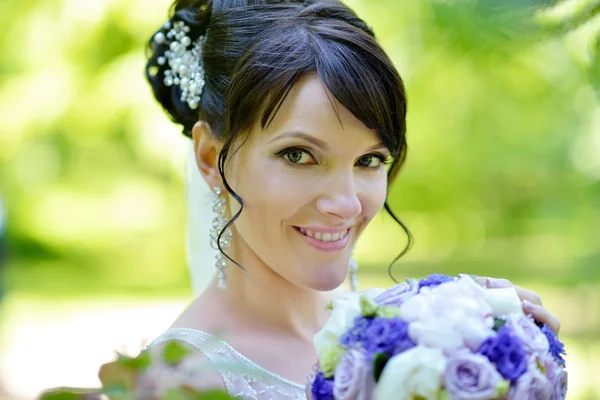 Beauty bride with bouquet on nature
