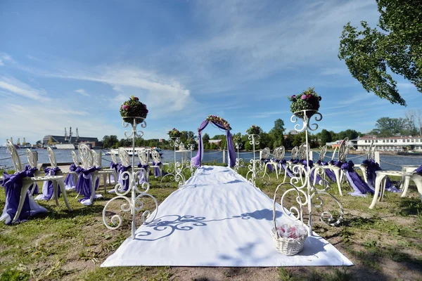 Purple wedding arch with flowers