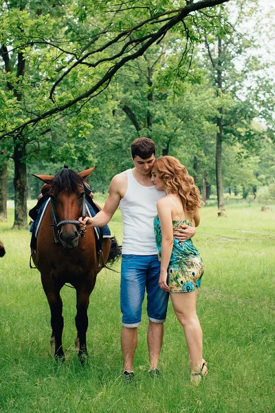 Lovers  on the background of horses
