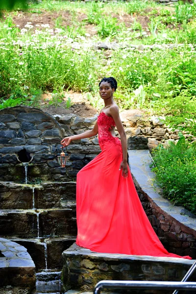 African girl standing at the waterfall