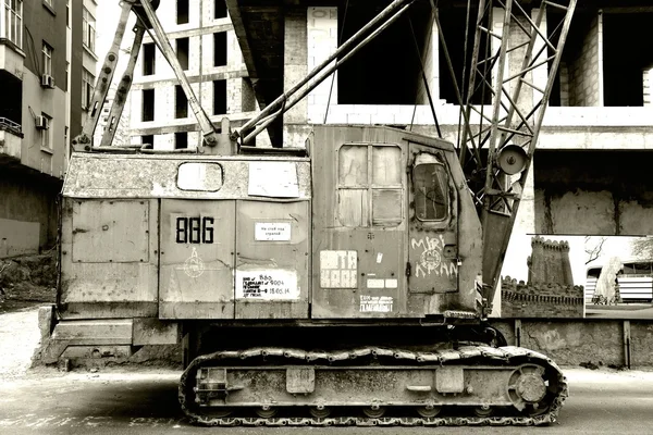 Old crane in front of construction site