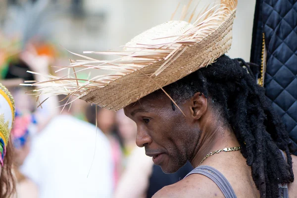 Man in straw hat with dreadlocks at Bath Carnival