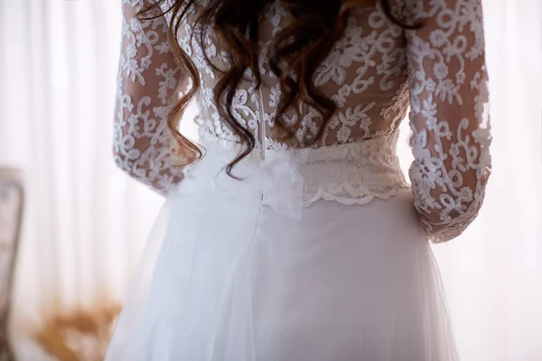Beautiful brides back. Morning of the . The  wears a  lace dress. Shoulder girl.  .