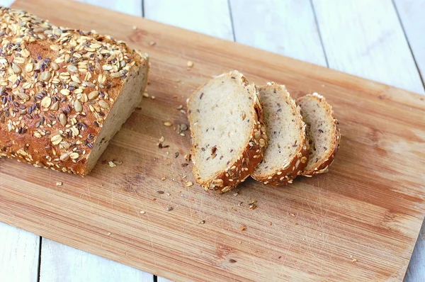 Wholegrain bread with seeds on the wood