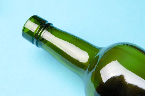 Empty wine bottle, its upper part. blue background
