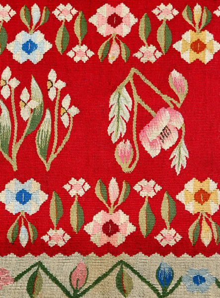 Fabric carpet pattern with colorful floral ornament.