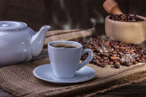 Coffee cup and coffee beans with  smoke