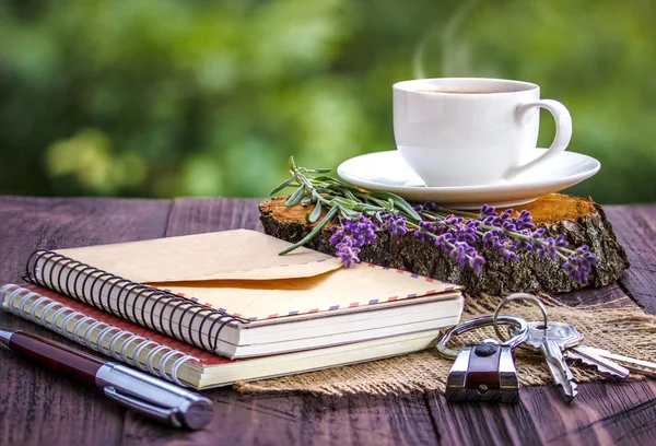 Blank white notebook,the keys, bunch of lavender and cup of coffee