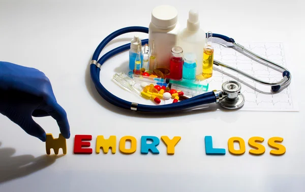 Diagnosis - Memory loss. Medical concept with pills, injection, stethoscope, cardiogram and a syringe