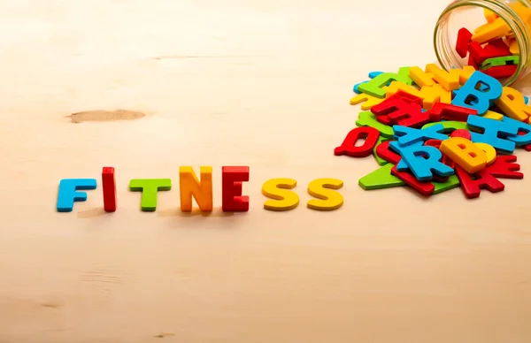 Fitness text on wood background