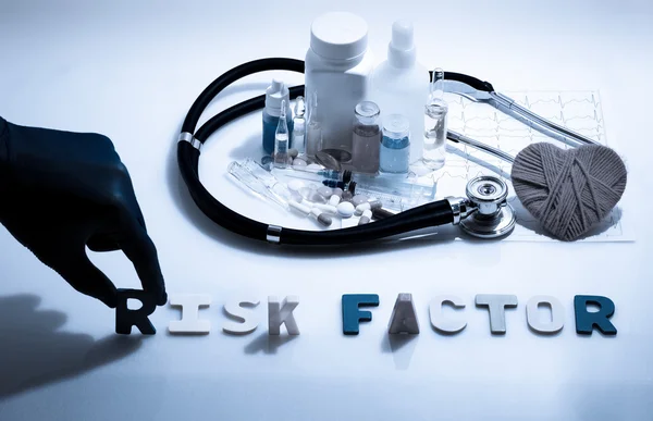 Risk factor. Medical concept with pills, injection, stethoscope, cardiogram and a syringe