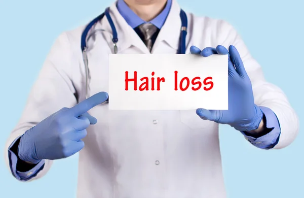 Doctor keeps a card with the name of the diagnosis - hair loss