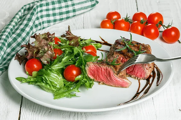 Steak and cherry tomatoes in a pansteak and cherry tomatoes in a pan