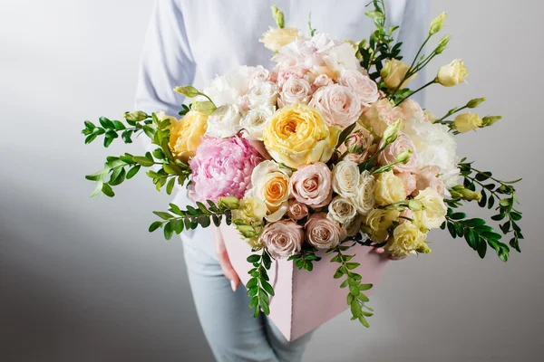 Flower composition with hydrangea and peonies. Color pink, green, lavander, blue. Kraft paper. crisp packaging