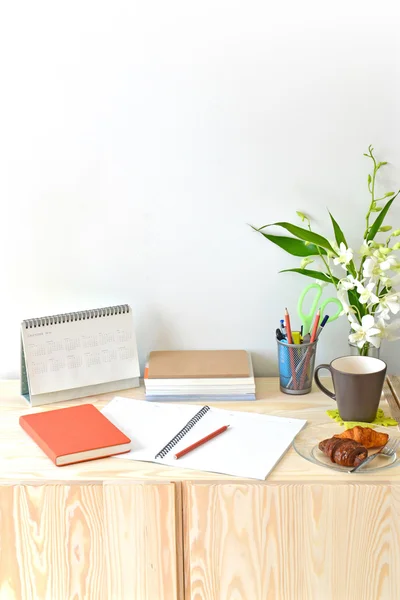 Home office table with notebook, calendar, office supply
